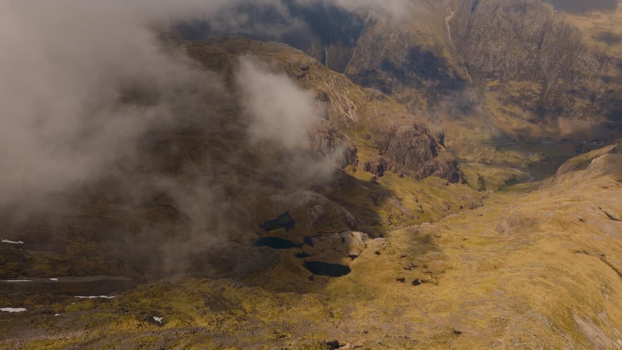 Aerial drone footage of Bidean Nam Bian, the highest mountain in Glencoe, Scotland. Sweeping views of peaks, deep valleys, and dramatic Highland scenery