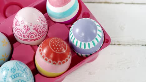 painted easter eggs in the pink tray