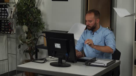 Frustrated-male-office-worker-throws-paperwork-in-the-air-in-slow-motion