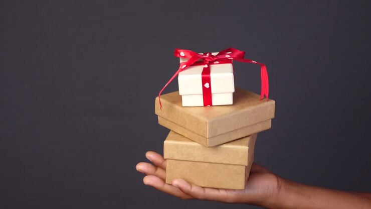 Child hand hold homemade gift box