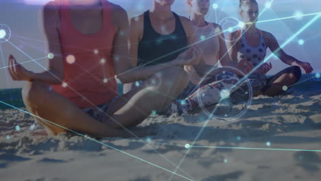 animation of glowing communication network over female friends doing yoga on sunny beach