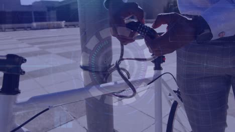 animation of data processing over african american businessman locking bike with lock chain