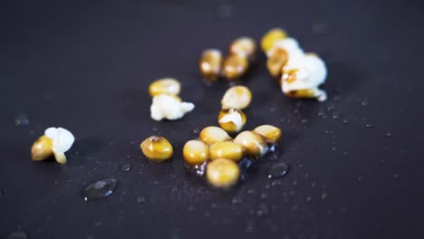 popcorn popping, exploding in slow motion in pan, close-up detail shot