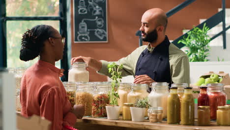 vendor presents bulk products in jars