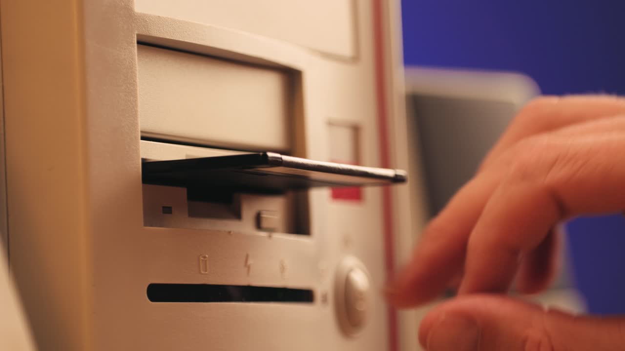 Using diskette for old computer. Music recorder, playing retro computer games. Vintage device for office, obsolete technology. . High quality 4k footage