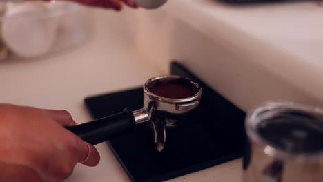 hands, coffee press and filter for espresso to