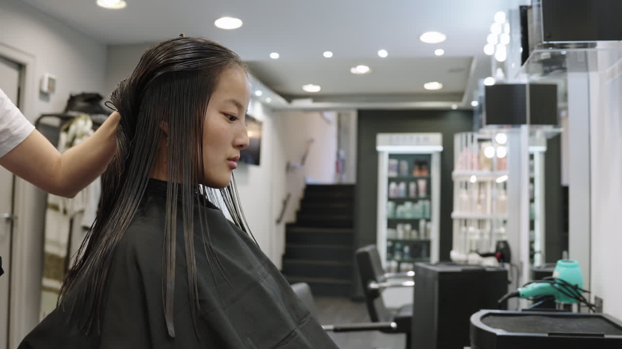 Asian woman getting a haircut in a hair salon