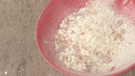 muesli pouring into a breakfast bowl