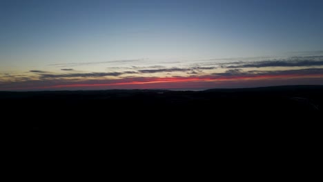 early morning sky before sunrise between clouds, haze skyline dark coastline