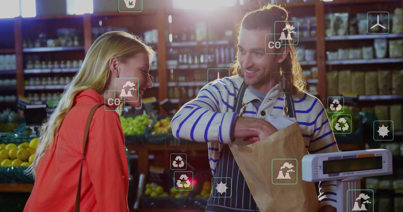Woman handing carrots at grocery causing clerk weighing bagging for purchase under fading CO? icons