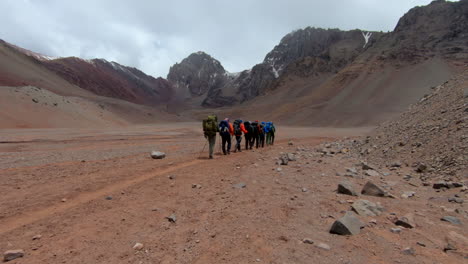 group of people hiking on the final approach to plaza argentina basecamp on the ascent to aconcagua