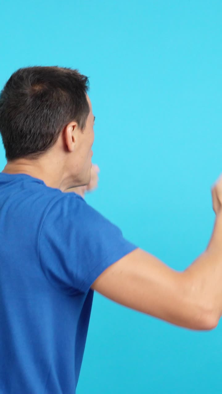 Rear view of a man waving a haitian pennant