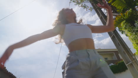 woman dancing outdoors on a sunny day