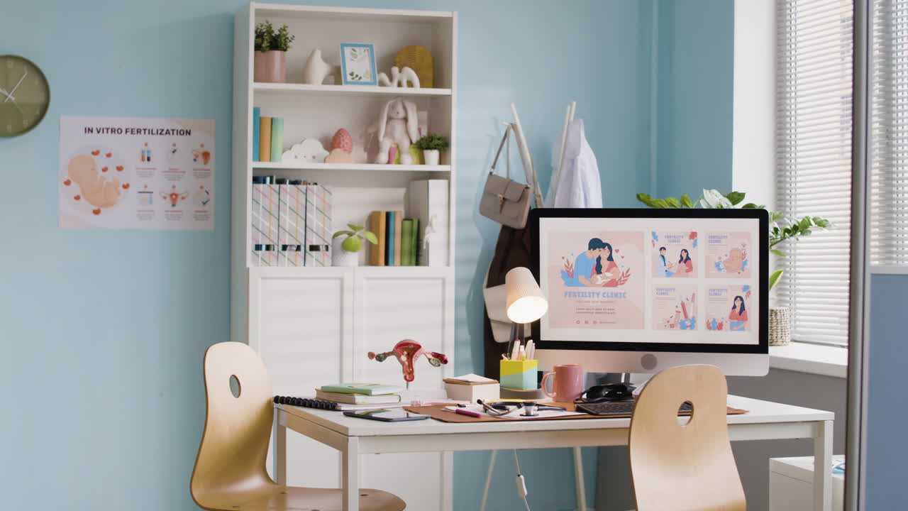 A fertility clinic doctor's office with a desk, computer, and medical decorations