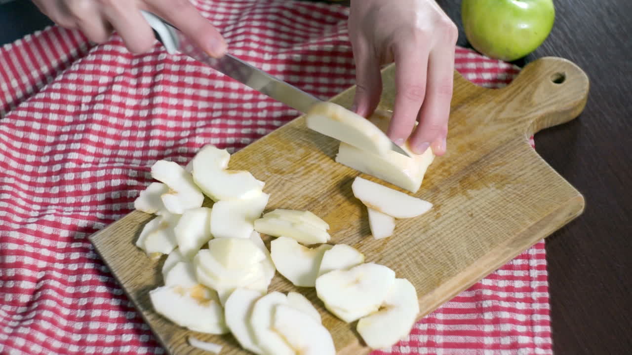 Cutting apple on slices.  Preparing ingredients for baking apple pie