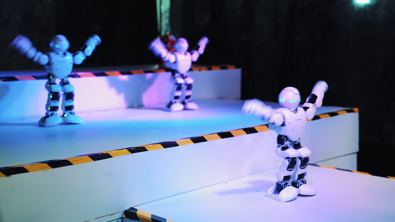 Humanoid robot dance. Group of cute robots dancing. Close up of smart robot dance show. Dancing robot performance. Robotic dance party. Smart robotic technology