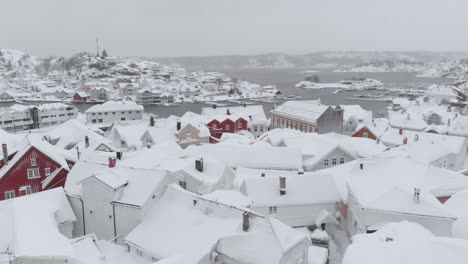 Kragero,-Telemark-County,-Norway---A-Snowy-Townscape-During-the-Winter-Season---Aerial-Pullback-Shot