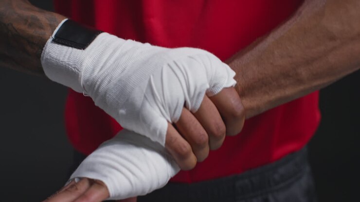 Real Time Close Up Of Male Boxer Wrapping Hands With Protective Bandages Before Boxing Match Or Training Session 3