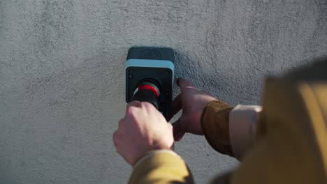 Woman-plugging-in-a-charger-to-a-wall-outlet