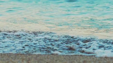 sea waves are splitting on a sandy shore in the summer. slow motion