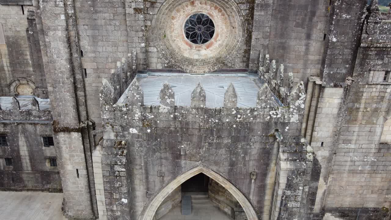 4K drone ascending and rotating flight over Tui Cathedral in Galicia, Spain, stunning aerial view of medieval religious architecture and historic old town