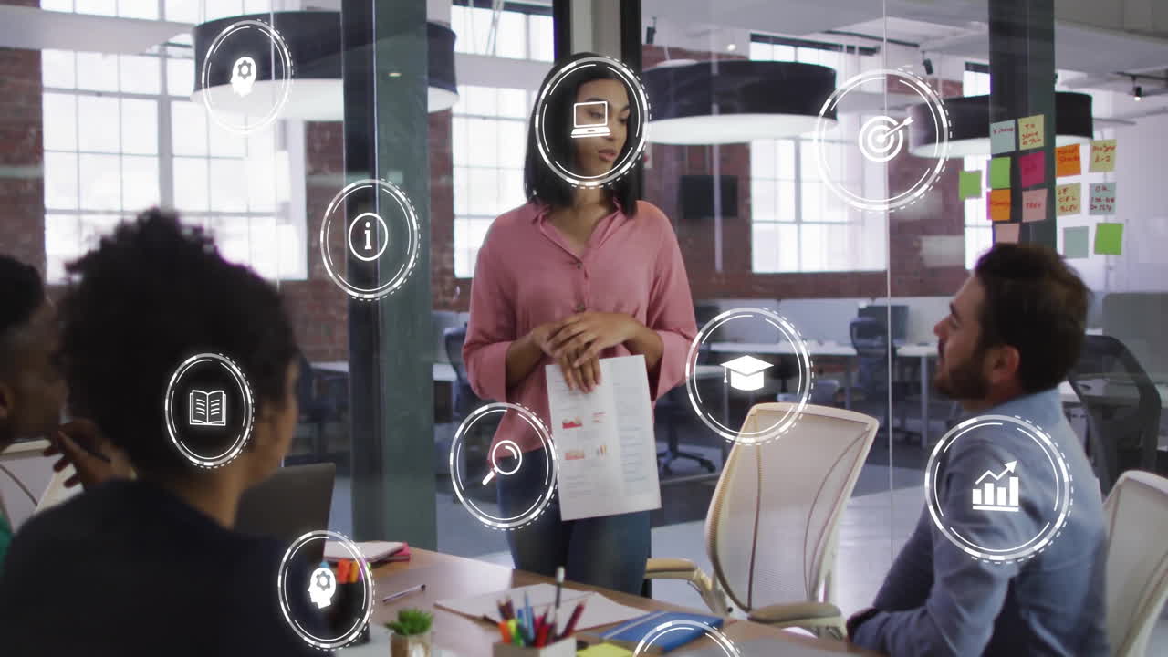 In office, diverse team in business meeting with digital icons overlaying animation