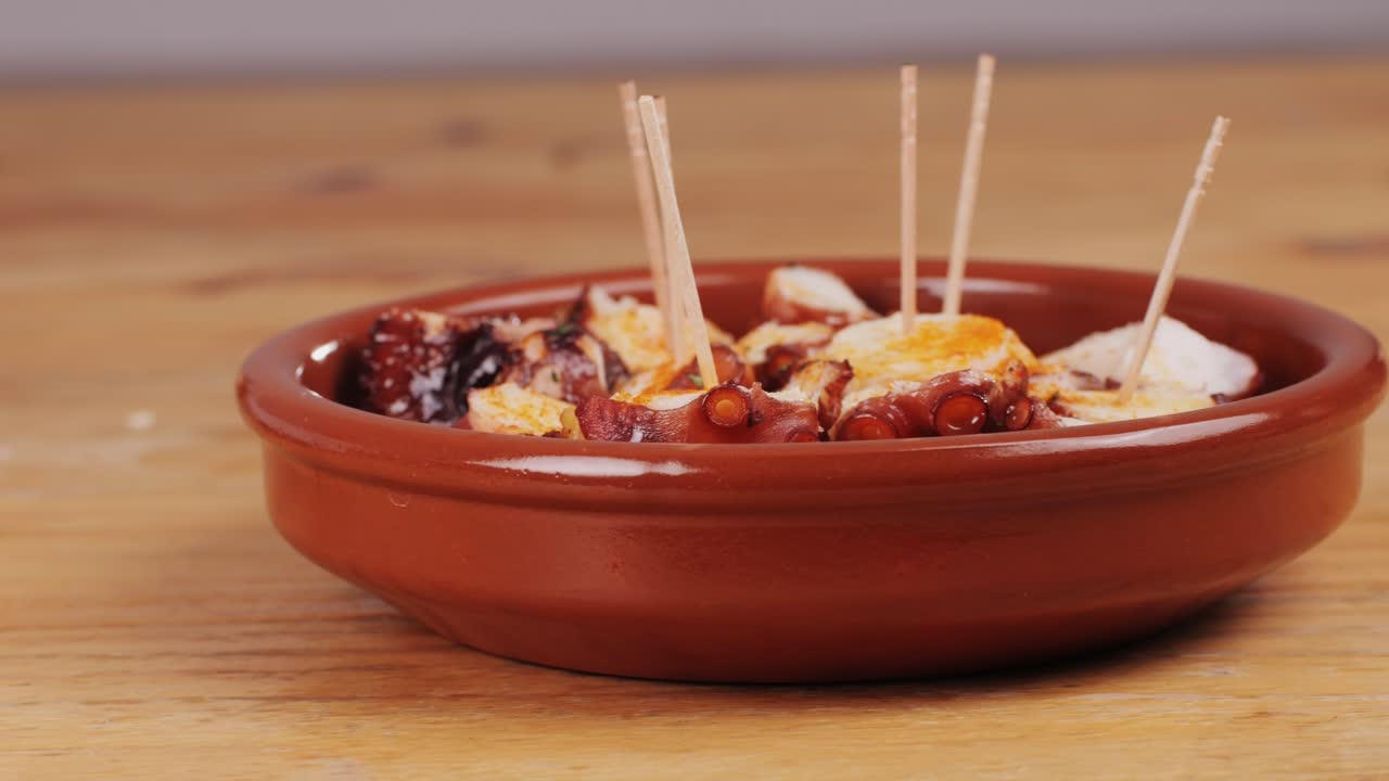 Octopus cooking, chef grill fresh octopus galician style on restaurant kitchen, healthy food, seafood cafe in spain, traditional asian japanese spanish and mediterranean dish.