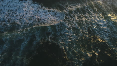 aerial top down view of ocean waves during a beautiful sunrise at miami beach gold coast australia