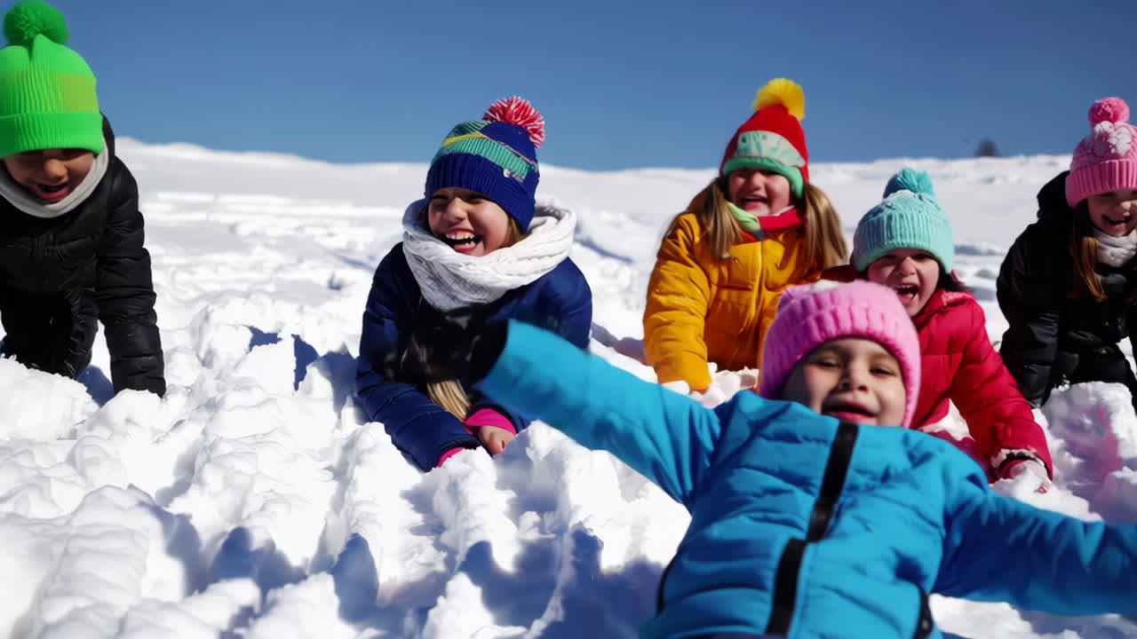 Children Playing in the Snow on a Sunny Winter Day