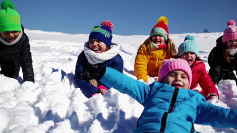 children playing in the snow on a sunny winter day