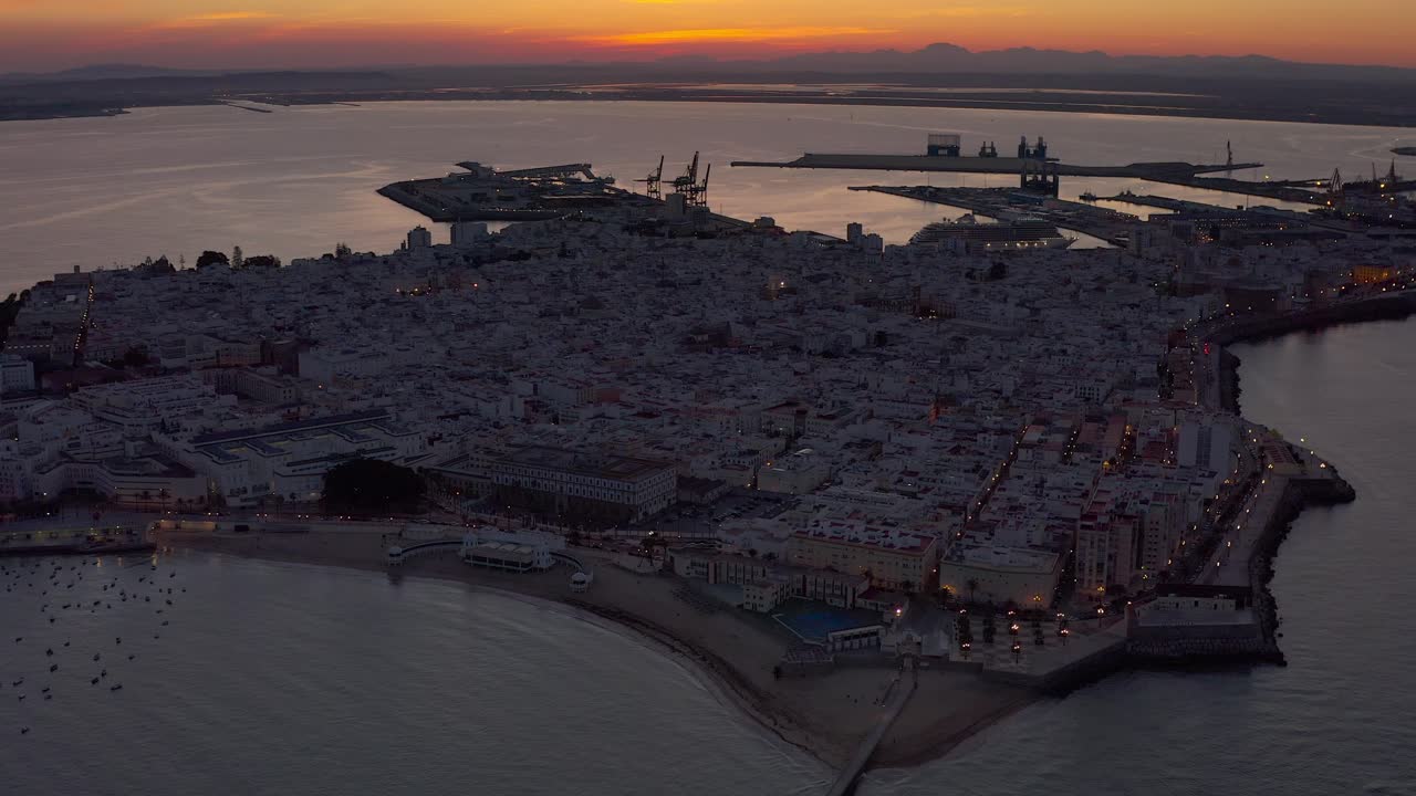 Aerial Sunset View of a Coastal City and Harbor