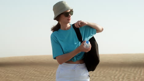 woman with water bottle and backpack