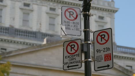 no parking signpost and notice in french language along the street in montreal, quebec, canada