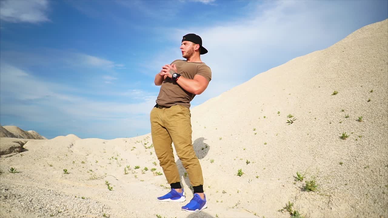 Man exercising outdoors in a sandy landscape