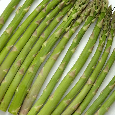 Green-fresh-and-healrhy-asparagus-placed-on-a-white-wooden-table--Top-view--Close-up