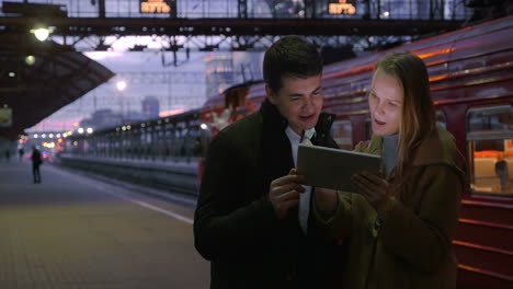 people using tablet pc at railroad station