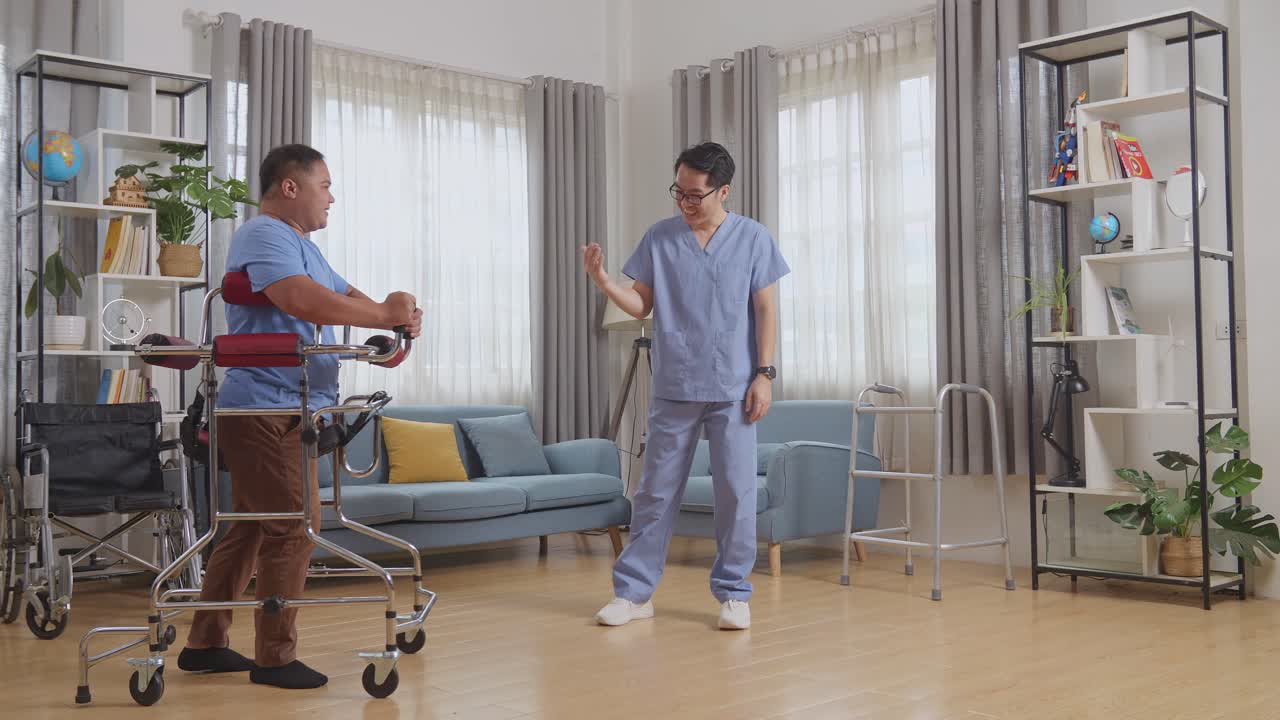 아시안 남성 간호사의 전체 몸의 측면 뷰는 커를 사용하는 환자에게 손을 흔들고 집에서 물리 치료 기간 동안 축하하는 손을 박고 있습니다.