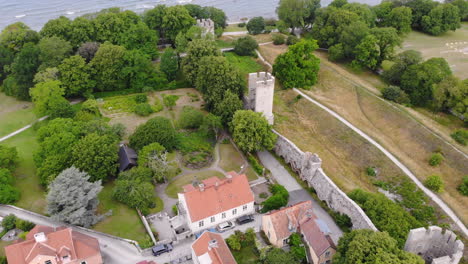 Vista-Aérea-De-La-Muralla-Medieval-De-La-Ciudad-De-Visby-Junto-A-Casas-Y-árboles-Verdes