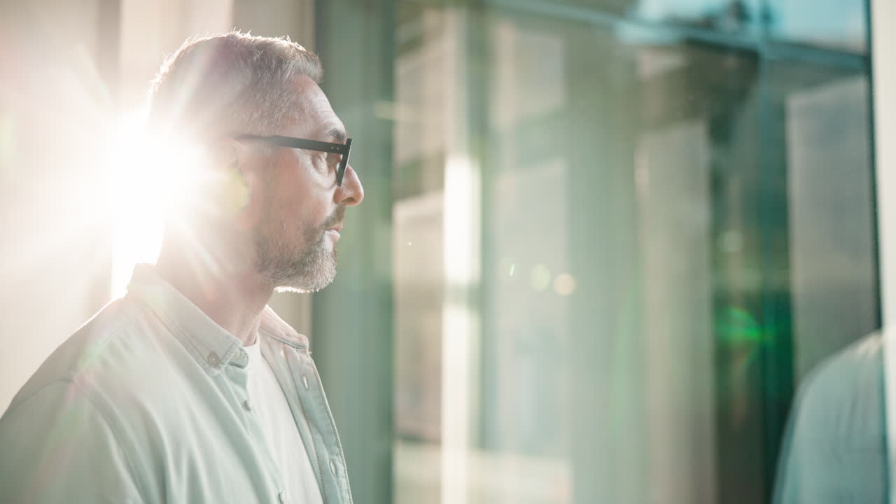 Contemplative Businessman Looking Out Window
