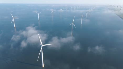 huge windmill turbines, offshore windmill farm in the ocean westermeerwind park , windmills isolated at sea on a beautiful bright day netherlands flevoland noordoostpolder