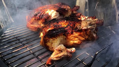 placing a temperature probe into chicken cooking on a bullet smoker