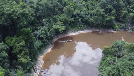 fishermen on the boat on the amazon river near iquitos, peru - aerial pullback