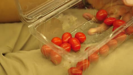 close-up-of-hands-taking-local-fruit-from