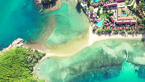 beautiful turquoise lagoon surrounding vacations resort on tropical island with green lush vegetation and sandy beaches in thailand