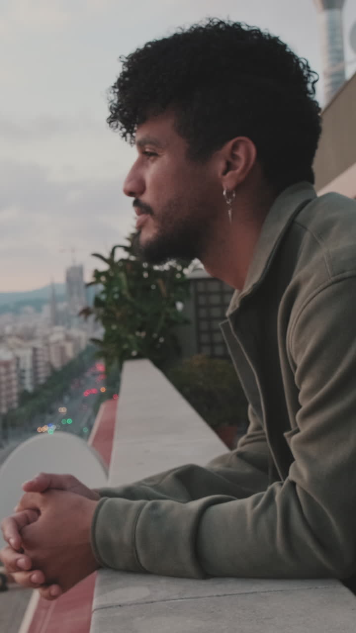 Man on a Balcony Overlooking the City