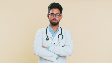 happy indian doctor man smiling looking at camera dreaming, resting, good news, feel satisfied