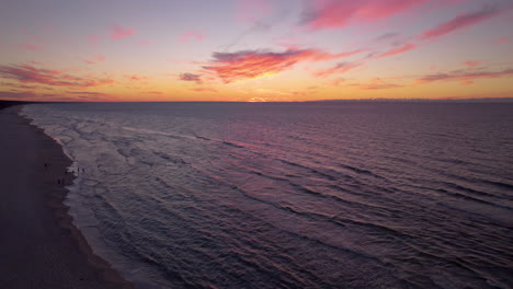 Cielo-De-Puesta-De-Sol-De-Color-Rosa-Colorido-Con-Nubes-Esponjosas-Sobre-El-Mar-Báltico-Y-La-Costa,-Polonia---Antena