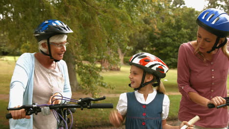 Happy-multi-generation-family-on-their-bike-at-the-park-