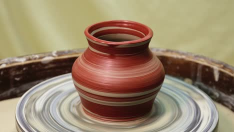 painted pot rotating on pottery wheel. just painted with brush