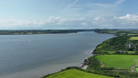 Vuelo-De-Drones-En-Duncannon-Wexford,-Irlanda,-Hasta-El-Estuario-Con-Pasaje-East-Village-Y-Ferry-Cruzando-El-Estuario